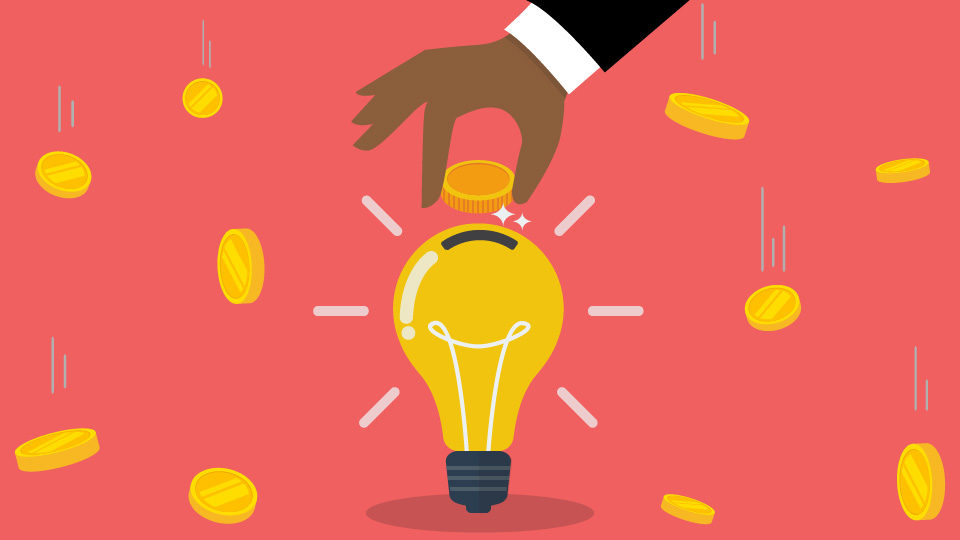 illustration of a hand placing a coin into a lightbulb-shaped piggy bank with coins falling around, symbolising startup funding and investment in business ideas